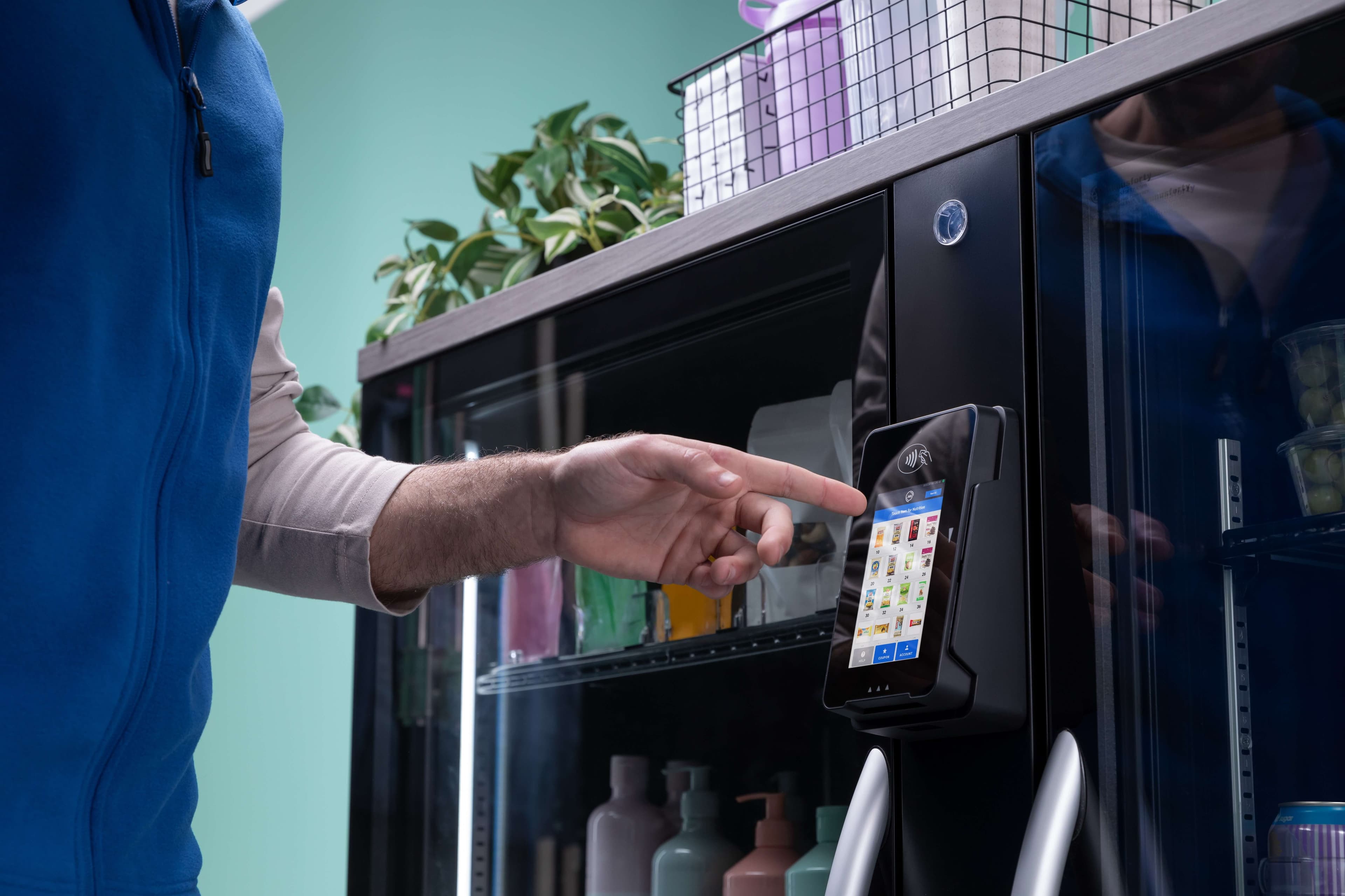 Close-up of a customer using the touchscreen on a Snaxology smart cooler